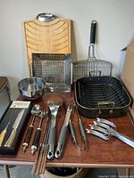 Group shot of all BBQ tools, roaster, pans and board