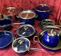 Group shot of all cookware pieces on red cloth