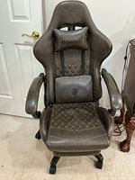 Front view of Dowinx brown gaming chair with cushions and armrests