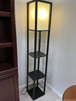 Full view of lamp showing shade lit and three shelves