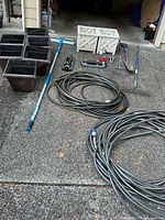 Lot overview showing planters, hoses, tools