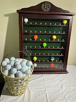 Front view of display case and bucket of golf balls
