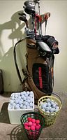 Full view of bag, clubs and three containers of balls