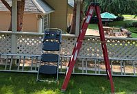 Group shot of all three items: red Werner ladder, aluminum extension ladder, folding stepstool