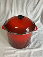 Stockpot with lid in place, showing red enamel exterior and handles