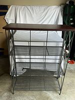 Front view of assembled metal shelf with top board in place