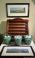 Overall lot showing two framed prints, wooden ball rack, three baskets of balls