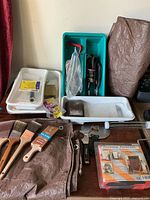 Overview of lot showing trays, brushes, drop cloth, sanding items, Forearm Forklift kit