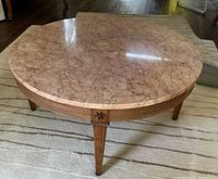 Angled view showing marble top and wooden base