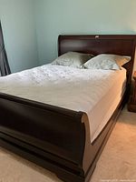 Full view of queen sleigh bed with mattress