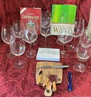 Full lot showing glasses, books, cheese board, utensils, corkscrew, markers