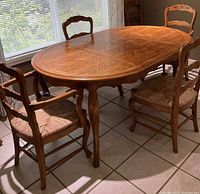 Full view of oval dining table with four chairs visible
