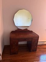 Mirror on vanity showing full shape and base