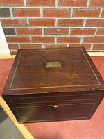 Closed wood humidor showing exterior finish, brass trim and lock