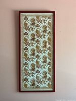 Full view of framed batik textile wall art on wall