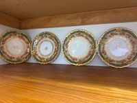 All four matching plates displayed upright
