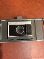 Front view of Polaroid Land Camera J66 showing lens and light meter