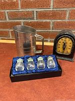 All items grouped: four shakers in box, sifter, timer