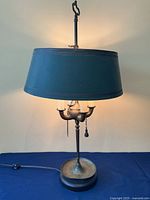 Full view of bouillotte lamp with shade illuminated