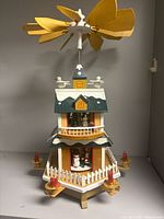 Full view of pyramid carousel front with candles and fence