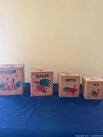 All four canisters side by side showing labels and size variation
