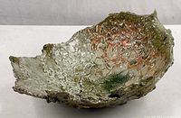 Full view of textured ceramic bowl showing interior colors and irregular rim