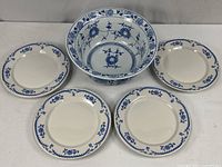 Group shot of bowl centered with four plates around