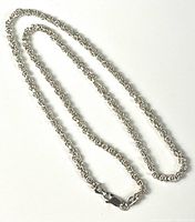 Full view of entire Italian sterling silver chain necklace laid out showing length and lobster clasp