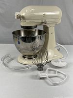Mixer with bowl and attachments displayed