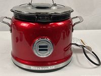 Front view of red KitchenAid KMC4241 multi-cooker showing brand logo and control panel