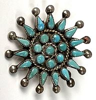 Front view showing turquoise cabochons and silver sunburst design