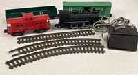 All items together: locomotive, three cars, transformer, three track pieces