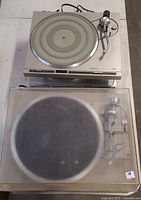 Silver Pioneer turntable with platter and tonearm plus taupe unit with dust cover