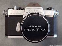 Front view of camera showing Asahi Pentax branding and lens cap in place