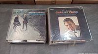 Two stacks of LPs; top titles "Sounds of Silence" and "The Best of Charley Pride"