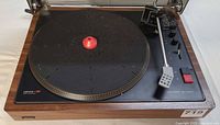 Full view of Lenco L90 turntable showing platter, plinth and dust cover