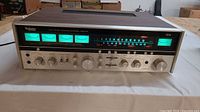 Front view of Technics SA-8000X receiver powered on showing meters and controls