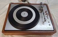 Top view of Lenco L85 showing platter, tonearm and wood base