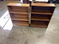 Both bookcases side by side showing overall condition and height