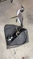 Bag containing flat silhouette goose decoys with one decoy displayed outside