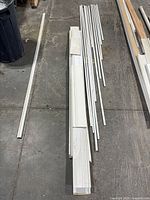 Top view of assorted white trim pieces laid out on floor