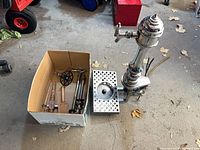 Overall view of chrome tower, drip tray and box of accessories