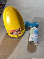 Fox40 bailer container and push-button signal horn side by side