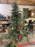 Full view of 92-inch artificial Christmas tree with red bear ornaments; lower right shows part of garland or wreath