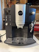 Front view showing full machine, drip tray, display and brand badge