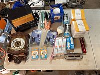 Overview of all items on table including bulbs, clock, candles, book lights, hand warmers and air cleaner