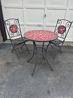 Full view of two chairs and table; focal chair style, color, mosaic medallion