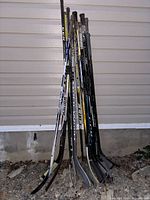 Full view of all sticks leaned against wall