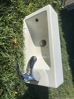 Front angled view showing sink basin, faucet and drain