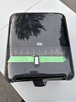 Front view showing Tork logo, translucent window, taped key